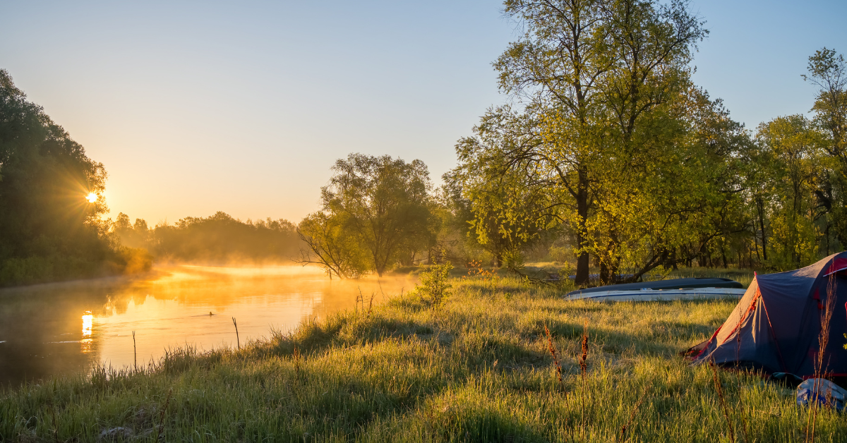 Misty sunrise over a river campsite on rural acreage, evaluated for recreational land investment potential