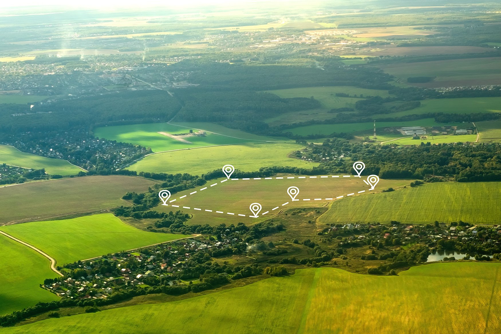 Aerial view of countryside farmland and forests.