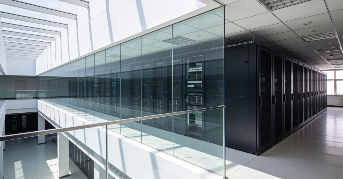 Modern enterprise data center facility floor showing server racks for colocation vs. owning land evaluation.