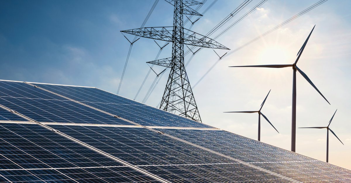 Solar panels and wind turbines positioned near electrical transmission power lines, representing renewable energy land deals and interconnection network upgrade costs evaluated on Acres