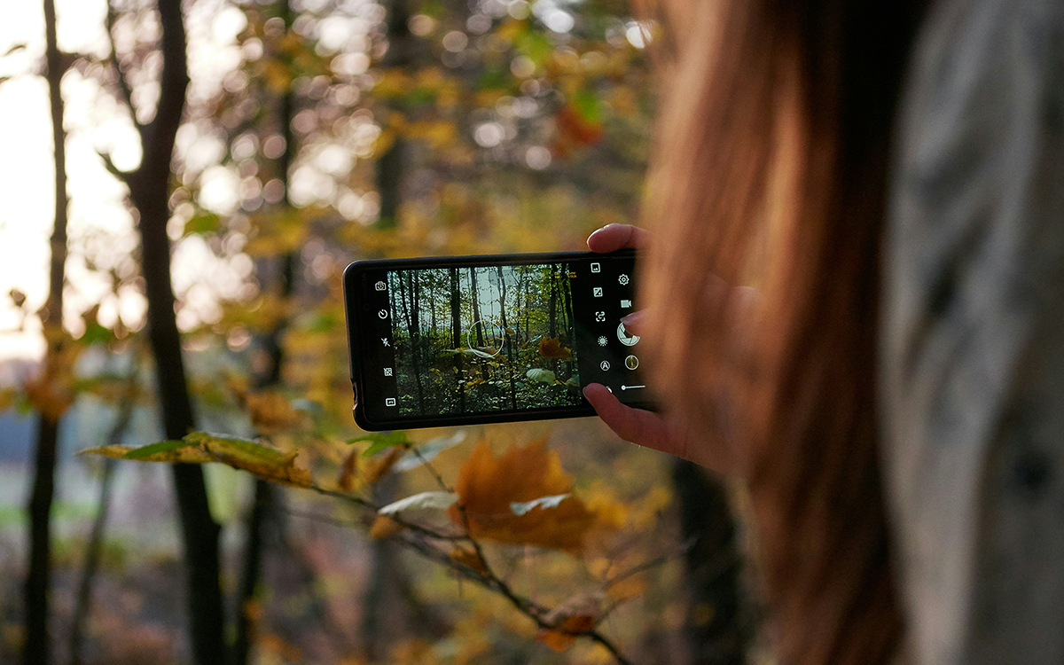 person taking a photo of land with a mobile phone